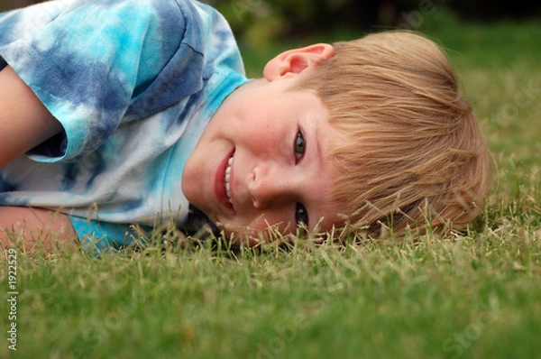 Fototapeta boy lying in grass