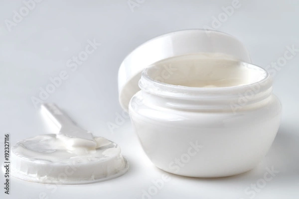 Obraz Open jar with face cream on a white background