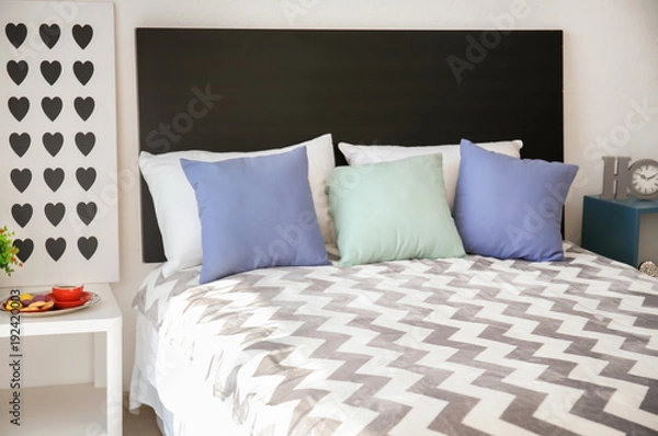 Fototapeta Comfortable bed in room interior