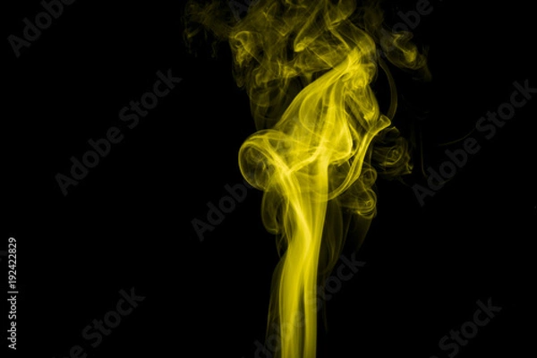 Obraz Yellow smoke on black background