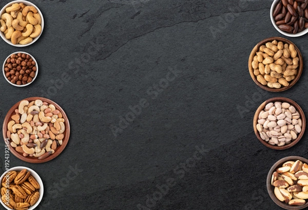 Obraz Assorted nuts over stone background with copy space