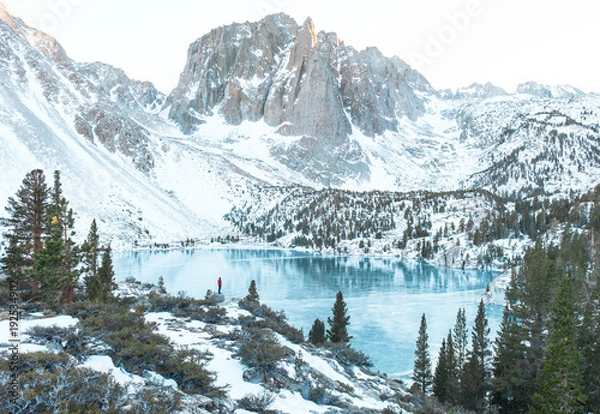 Fototapeta The might Temple Crag stands guard over Lake Two of Big Pine Lakes while a man looks on
