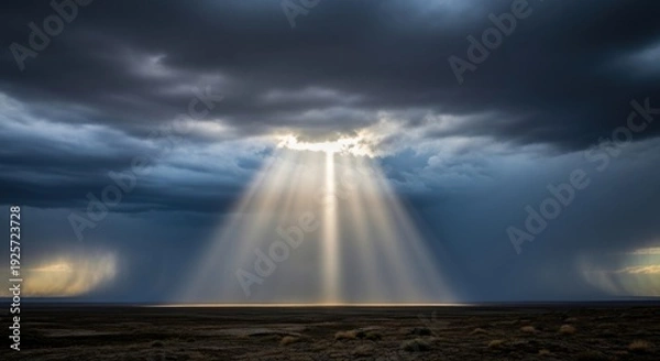 Obraz Dramatic Sky and Sunlight Beams Shining Through Clouds Over Landscape.