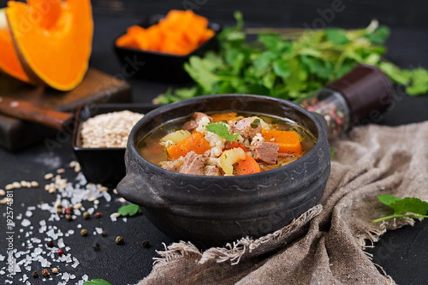 Fototapeta Thick soup with beef, pearl barley, pumpkin and celery. Dietary menu.