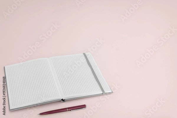 Obraz Open notebook with pen on pink background