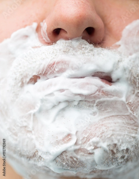 Fototapeta A man is applying face shaving foam