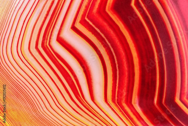 Fototapeta Amazing Banded Red Agate Crystal cross section as a background. Natural light translucent agate crystal surface,  Colorful abstract expressive structure slice mineral stone macro closeup
