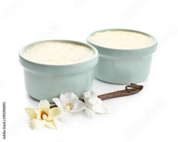 Fototapeta Ramekins with tasty vanilla pudding on white background