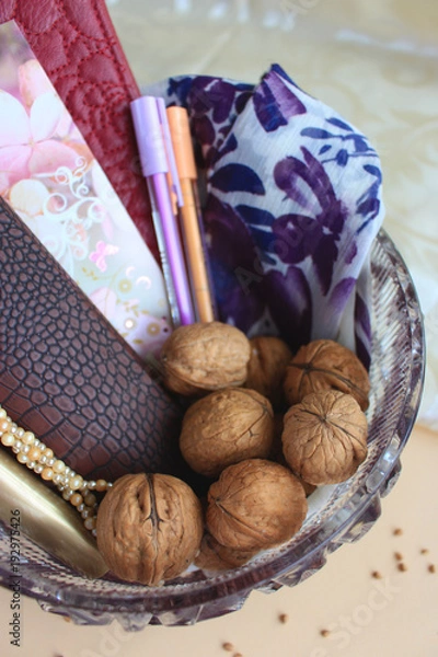 Obraz Composition with walnuts in glass vase on light background