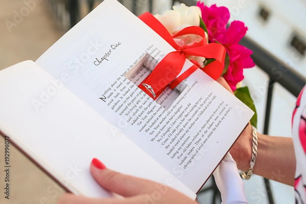 Fototapeta ring in a book with an engagement in hands