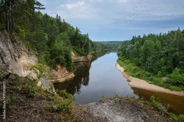 Fototapeta View from cliff on sandstone outcrops, river and forest. Erglu Cliffs, on the bank of the Gauja river.