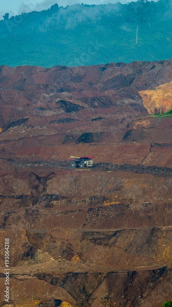 Fototapeta Unique landscape caused by open pit coal mining activity in Sangatta, Indonesia