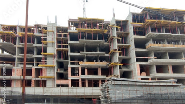 Obraz monolithic concrete residential complex under construction with multiple sections