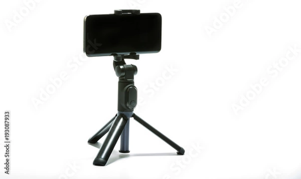 Fototapeta smart phone and tripod isolated on white background