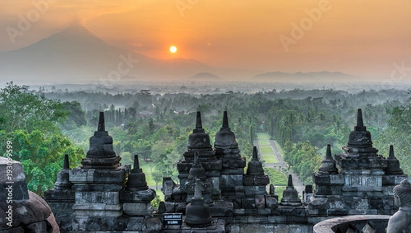 Obraz Sunrise panorama of Mount Merapi, Borobudur valey covered with mist and 9th century Stone Stupa at Borobudur Buddhist temple (UNESCO World Heritage Site). Magelang, East Java, Indonesia