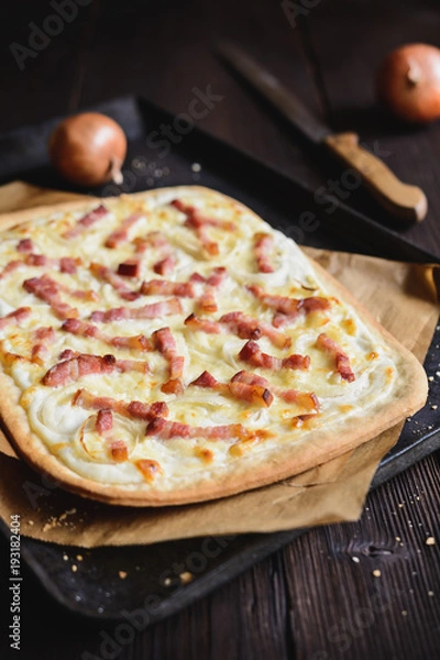 Fototapeta Traditional Tarte flambée with crème fraiche, cheese, onion and bacon