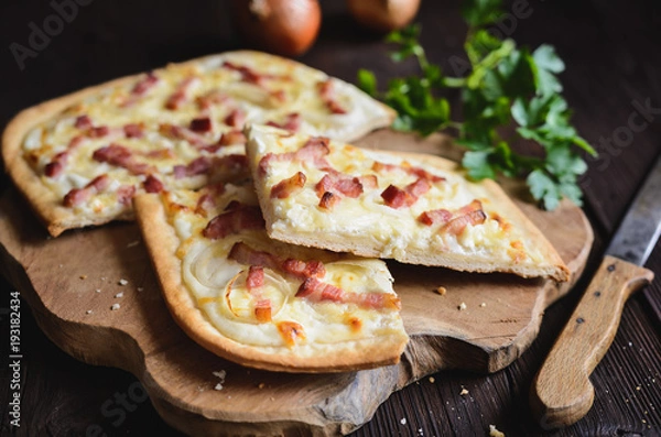 Fototapeta Traditional Tarte flambée with crème fraiche, cheese, onion and bacon