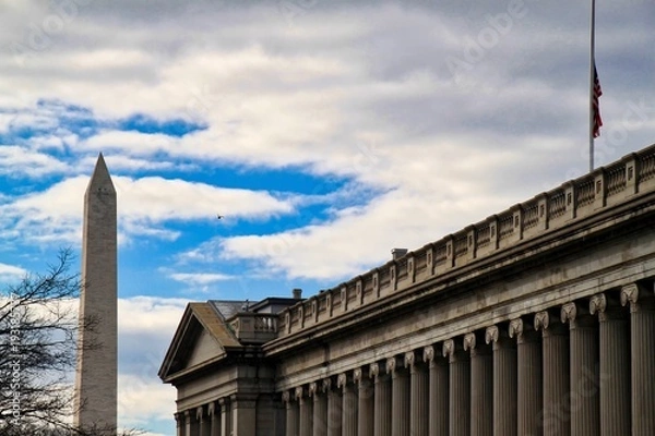 Fototapeta Washington Monument and U.S. Treasury Building on a cloudy day in Washington, D.C.