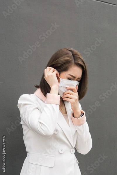 Obraz Asian woman wear protective face mask in pollution city with coughing., copy space for text