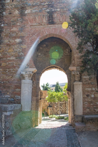 Fototapeta View on Malaga through a brick window of alcazaba