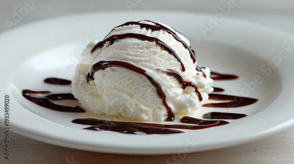 Obraz 白い皿に盛り付けたバニラアイスクリームに濃厚なチョコレートソースをかけたデザート
