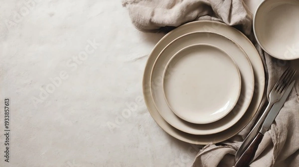 Fototapeta Elegant dining setup with neutral plates.