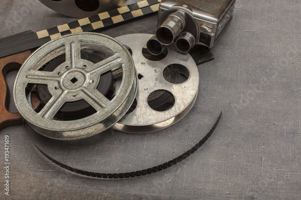 Fototapeta Old movie camera, film reels and clapperboards