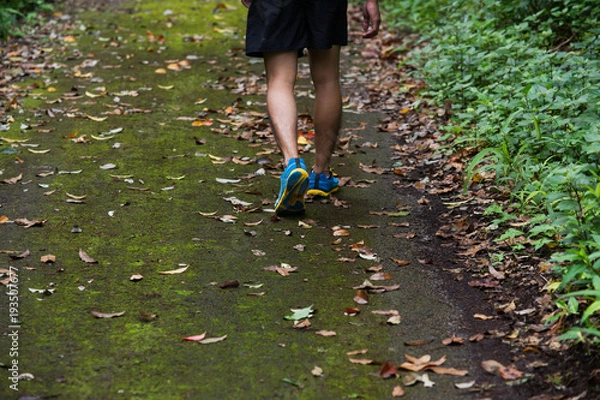 Fototapeta marathon runner running in rocks mountain. closeup of legs compression socks and shoes