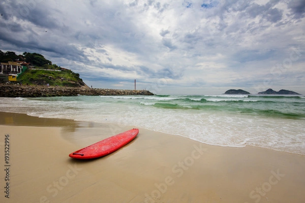 Obraz red surfboard laying on shorebreak