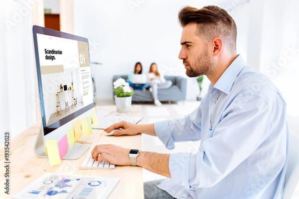 Fototapeta Hipster man interior design browsing e-magazine scandinavian design website