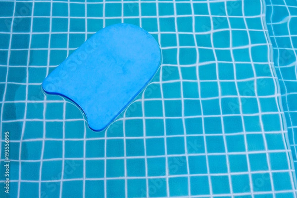 Obraz A blue swimming board floating on the pool water. Copy space.