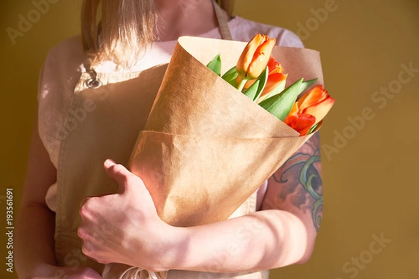 Obraz Florist holding a gift bouquet of tulips