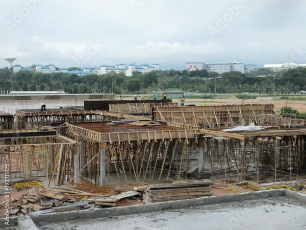 Obraz Construction workers fabricated timber form work at the construction site. Form work made from plywood and timber. 
