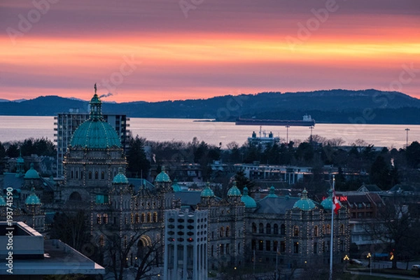 Fototapeta A colorful sundown over downtown Victoria, BC with buildings and a colorful sky