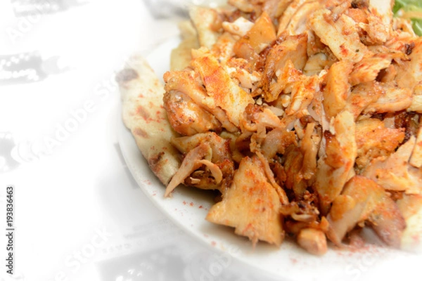 Fototapeta Close up of Gyros or Gyro, Greek dish made of meat cooked on a vertical rotisserie, traditionally pork, or chicken
