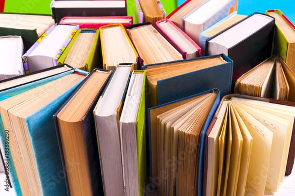 Fototapeta Open book, hardback books on bright colorful background.