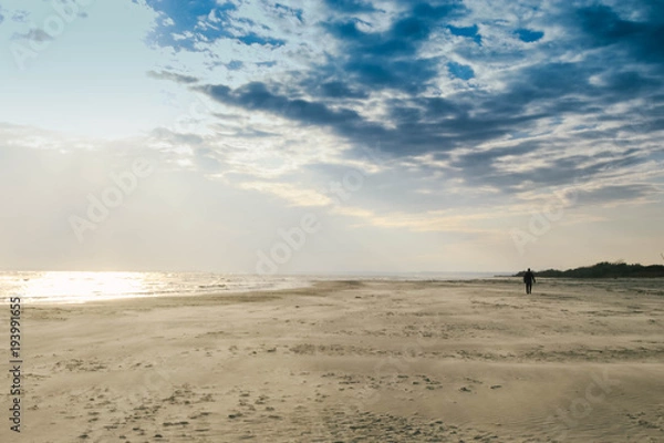 Obraz A man walking alone on a winter beach