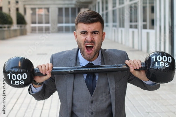 Fototapeta Funny businessman lifting heavy weights