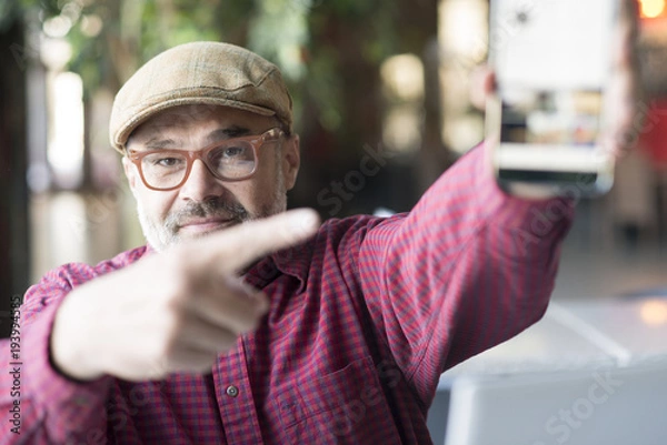 Obraz Adult man using smartphone application