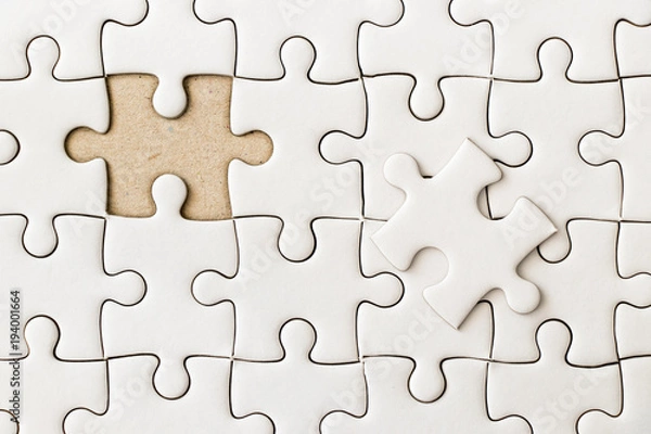 Fototapeta Closed up background of white plain jigsaw wait missing piece to match or fulfill