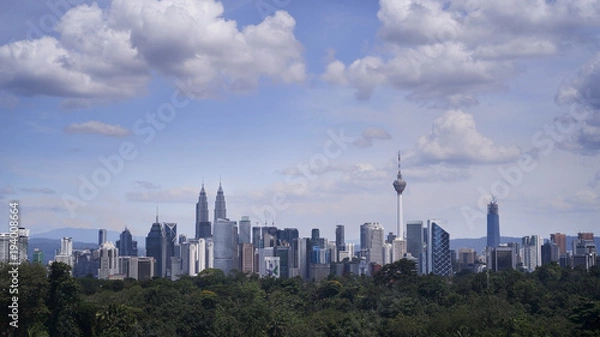 Fototapeta Kuala Lumpur city sky line at day light with blue sky and heavy cloud.