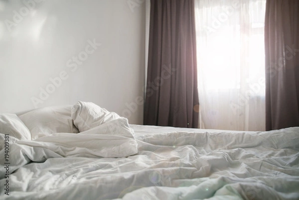 Obraz morning concept sunlight from the window on empty bed