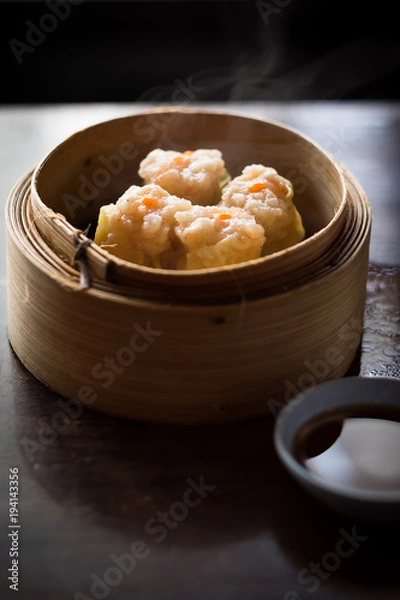 Fototapeta Shrimp Shumai, a steamed dish in bamboo containers with soy sauce