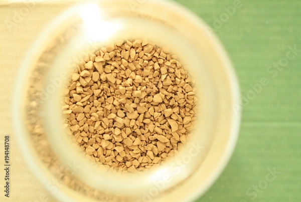 Fototapeta Top view of blended coffee in bottle with green and brown background