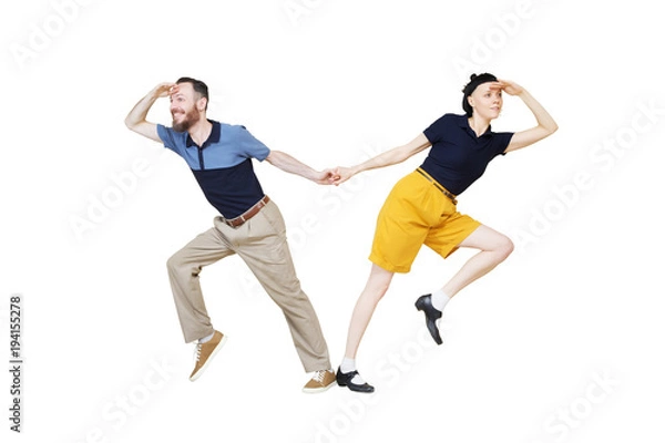 Fototapeta Dancers are looking for something. Boogie or lindy hop in a studio background. Dance for rock-n-roll music.