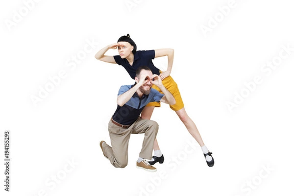 Fototapeta Dancers are looking for something. Boogie or lindy hop in a studio background. Dance for rock-n-roll music.
