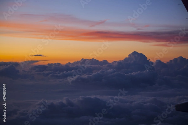 Fototapeta Sunrise over clouds