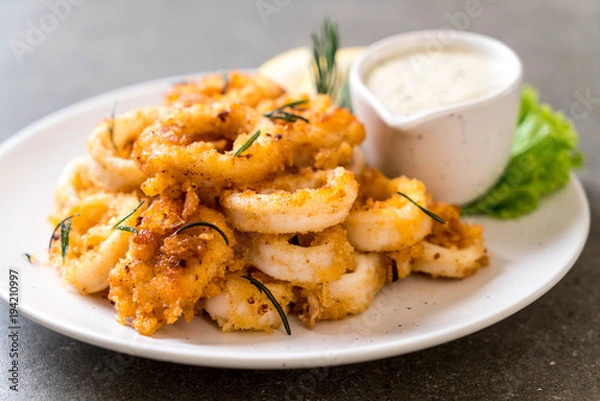 Fototapeta fried squids or octopus (calamari) with sauce