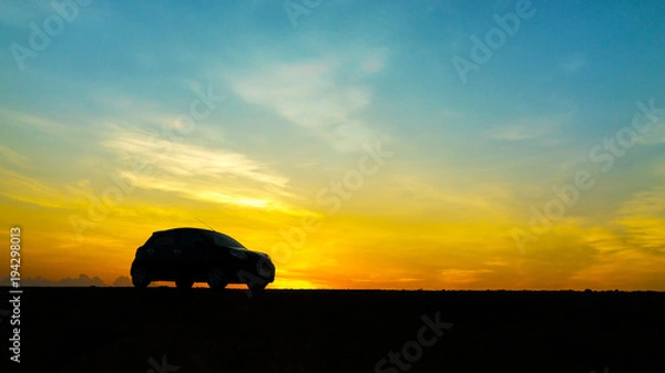 Fototapeta Cars parked on rural road in the morning have sunrise background