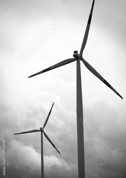 Fototapeta Windmills against a cloudy sky